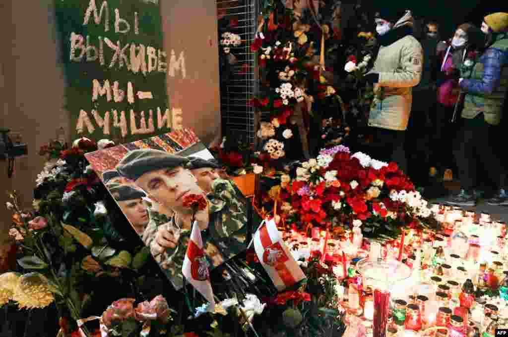 Mourners lay flowers at the impromptu shrine to Bandarenko below the graffiti reading: ""We will survive, we are the best."&nbsp;