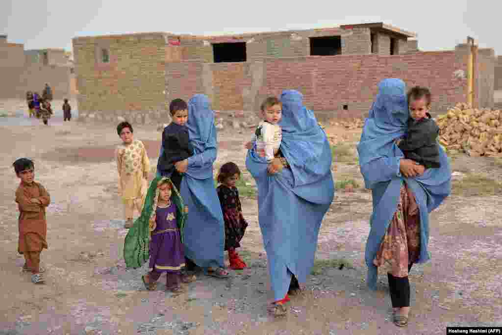 An internally displaced Afghan family who fled their home ahead of fighting between Taliban and Afghan security forces in the Enjil district of Herat on July 8.&nbsp;