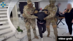 A screenshot from a video posted on the YouTube channel of the Security Service of Ukraine on May 9 shows the detention of a man suspected of espionage.