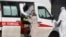 Medical workers wearing protective clothing take a suspected COVID-19 patient into quarantine. One Russian NGO says it's been contacted by many people in quarantine who feel abandoned without information.