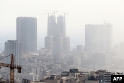 Smoke lingers in the sky above Tehran following an Israeli strike on June 18, on the sixth day of fighting between Iran and Israel.