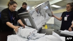 Members of a local electoral commission count ballots during at a polling station in Novosibirsk, Russia, on March 17.