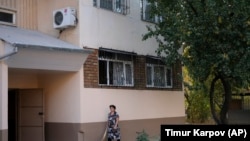 A local resident walks outside the apartment block in Tashkent where Sayfullo Saipov, the suspect in the New York terror attack, reportedly lived between 1996 and 2006, according to police records.