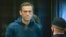 Russian opposition leader Aleksei Navalny stands in the cage during a court hearing in Moscow earlier this year. 