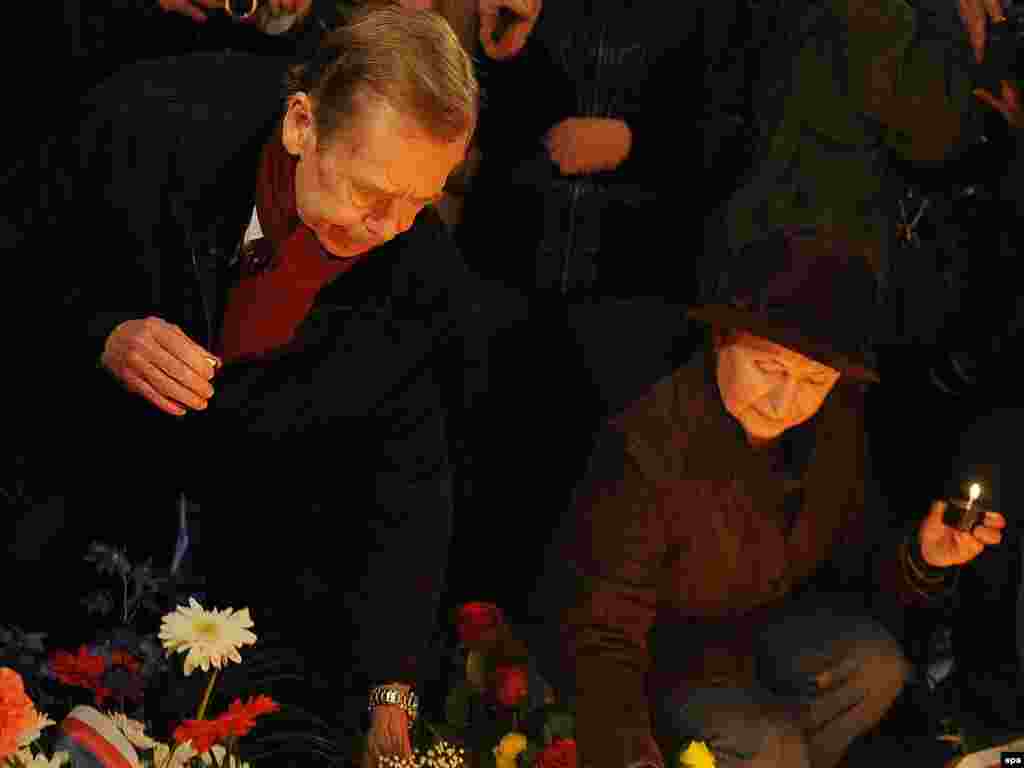 Havel (left) lights candles at the students' memorial on National Avenue in Prague on November 17, 2009.