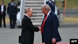 Президент США Дональд Трамп вітає президента Росії Володимира Путіна на злітній смузі після їхнього прибуття на базу Елмендорф-Річардсон в Анкориджі, Аляска, 15 серпня 2025 року