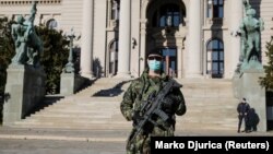 A Serbian soldier patrols in front of the parliament building in Belgrade as the number of coronavirus cases grow around the world on March 16.