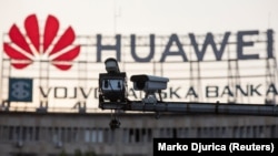 A surveillance camera is seen in front of a Huawei logo in Belgrade, Serbia. (File photo)