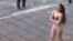 This image grab from a UGC video posted on November 2, 2024 and widely shared on social media, shows a female student in her underwear outside Tehran's Islamic Azad University.