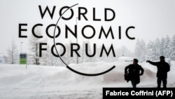 SWITZERLAND -- A security guard show the way to a man outside of the Davos Congress Centre under snow ahead of the opening of the World Economic Forum (WEF) 2018 annual meeting, in Davos, January 22, 2018