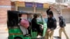 Police officers forcing a rickshaw driver to stop working during a nation-wide lockdown to curb the spread of the coronavirus in the southern city of Hyderabad in Sindh Province on April 3.