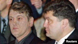 President Viktor Yushchenko (left) and the secretary of the National Defense and Security Council, Petro Poroshenko, attend a party convention in Kyiv in March 2005.
