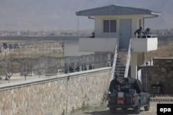 FILE: Afghan security forces stand guard at Pol-e Charkhi prison.