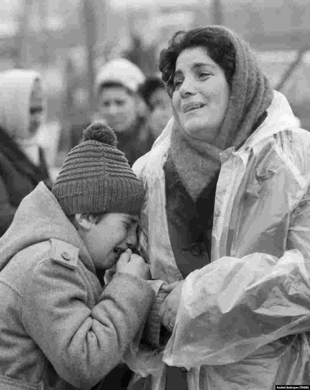 Grieving locals near their destroyed house. Gorbachev declared, "In my entire life, I've never seen one-thousandth of the suffering I've seen here.&rdquo;
