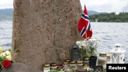 Flowers and candles on the shore near Utoeya island