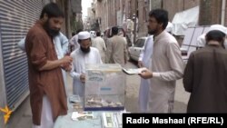 Members of Jammat-ud Dawa selling their newspaper and raising funds in Peshawar.