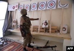 A Pakistani soldier looks at a training center of militants seized in North Waziristan.