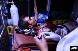 An injured Afghan man injured in the attack receives treatment in an ambulance.