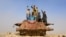 Afghan children play on the remains of a Soviet-era tank on the outskirts of Jalalabad in February.