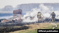 Firefighters tackle the blaze in the village of Karakul.
