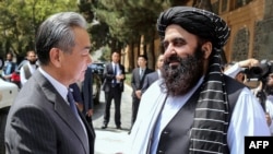 Taliban Foreign Minister Amir Khan Muttaqi welcomes Chinese Foreign Minister Wang Yi to Kabul ahead of a August 20 trilateral meeting with Pakistan. 