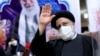Ebrahim Raisi waves to journalists while registering his candidacy for the upcoming presidential election at the Interior Ministry in Tehran on May 15. 