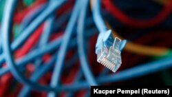 Ilustrație cu un cablu de internet într-o sală de servere. 