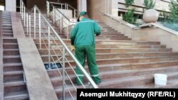 Работник перед зданием министерства труда Казахстана. Иллюстративное фото