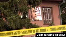 A photo of Oliver Ivanovic is posted on the building of his office in Mitrovica near where he was assassinated on the morning of January 16.