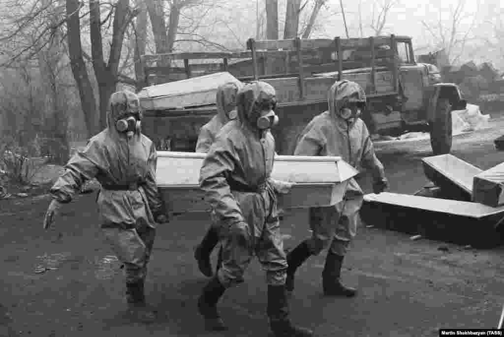 Workers transporting a coffin. Unlike previous carefully censored disasters in the Soviet Union, the earthquake's aftermath took place under the glare of a newly unleashed Soviet media, thanks to Gorbachev's policy of glasnost, or "openness."