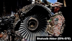 FILE: The wreckage of a state-run Pakistan International Airlines, Airbus A320 lies amid houses days after it crashed in the southern seaport city of Karachi in May 24.