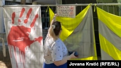 Student Jelena Stankovic places signs at an exhibition on the university campus in Novi Sad, Serbia, on August 24.