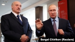 Russian President Vladimir Putin (right) speaks next to Belarusian President Alyaksandr Lukashenka during their meeting in the Black sea resort of Sochi on February 15.