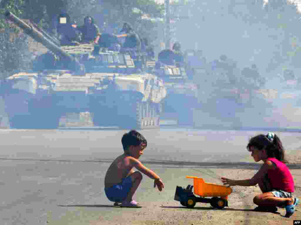 Russian tanks move through Tskhinvali in August 2008. In early August 2008, South Ossetian forces began shelling Georgian villages and Georgian forces retaliated. Each side accused the other of initiating the violence. On August 7, Georgia moved in troops and attempted to regain control of South Ossetia. Moscow responded quickly with a large force of tanks and troops, driving Georgian troops back and occupying a number of towns before a cease-fire on August 12.