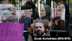 Demonstrators hold portraits of Zelimkhan Khangoshvili in front of the German Embassy in Tbilisi in September.