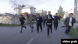 Жеңишбек Токторбаев Ошто кызматкерлер менен көчөнү кыдырып жүргөн учур. Сергей Лапушкин оң жактан эң четте фотоаппарат көтөрүп баратат.