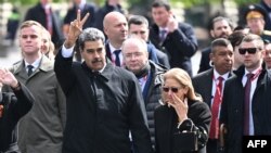 Predsednik Venecuele Nikolas Maduro gestikulira dok on i njegova supruga Silija Flores napuštaju Crveni trg nakon vojne parade povodom Dana pobede u centru Moskve 9. maja 2025.