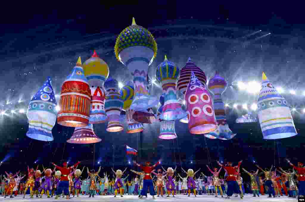 Dancers perform amid a spectacular balloon display representing Moscow's St. Basil's cathedral.