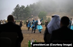 Президент Илһам Алиев (сулда) Шушадагы тамашаны карый. 2025 елның сентябре.