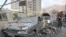 People gather near damaged vehicles in the aftermath of Israeli strikes, in Tehran, Iran, June 13, 2025