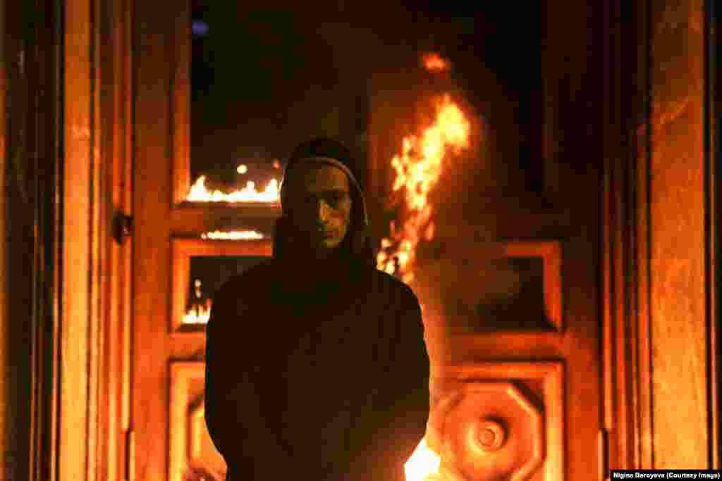 The pair trailed the hooded figure through an underpass. Beroyeva remembers: "We came up and could see he was doing something against this door and then the fire started very suddenly. We only grabbed our cameras out of our bags then."