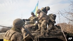Ukrainian soldiers take up positions on the front line at an undisclosed location in the Donetsk region on November 24.