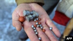 Протестувальник тримає набої, якими стріляє міліція