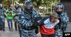 Russian National Guardsmen detain a man following a rally calling for fair elections in central Moscow on August 10.