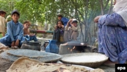 A woman prepares meal for her family displaced from North Waziristan.