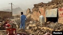 People search the debris of damaged buildings in the aftermath of an earthquake in Samangan Province, Afghanistan, on November 3. 