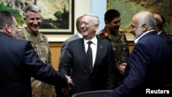 U.S. Defense Secretary James Mattis (C) and U.S. Army General John Nicholson (2nd L), commander of U.S. Forces Afghanistan meeting Afghanistan's National Directorate of Security Director Mohammad Masoom Stanekzai (R) and other members of the Afghan delegation at Resolute Support headquarters in Kabul on April 24.