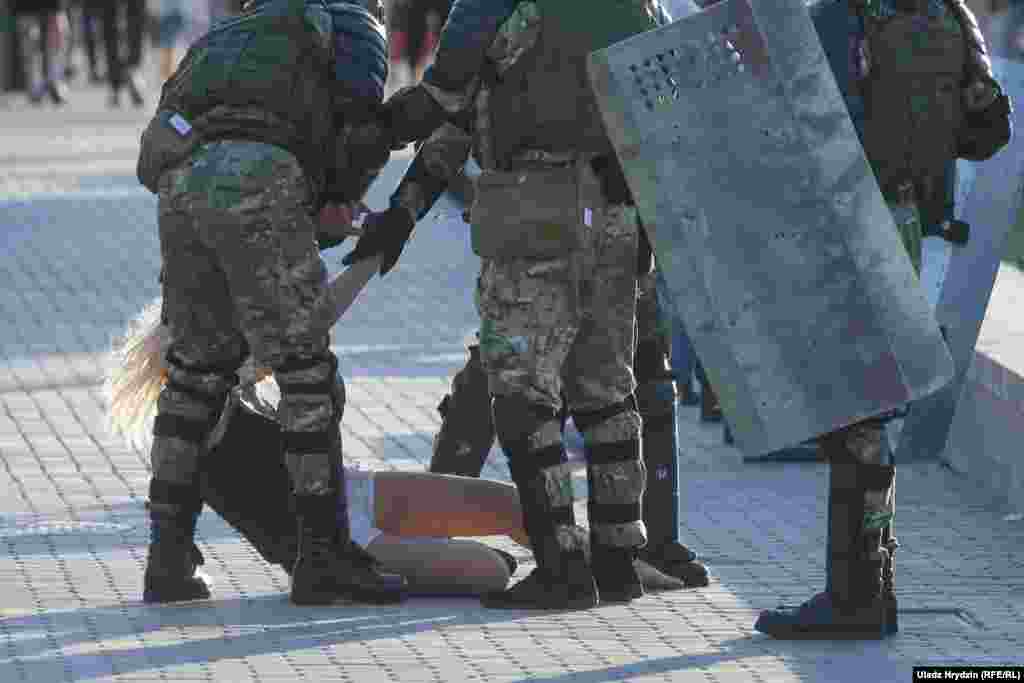 Police surround a woman in Minsk on August 11.