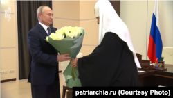 Владимир Путин (слева) и Патриах Кирилл