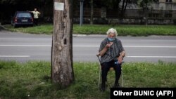 A woman waits for a health check in front of a COVID-19 medical center in Belgrade on July 2.